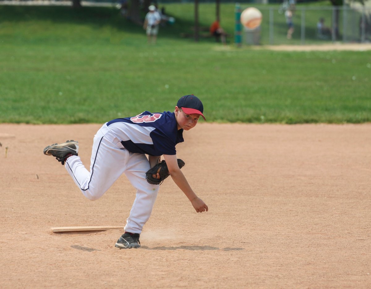 Young male baseball player fielding