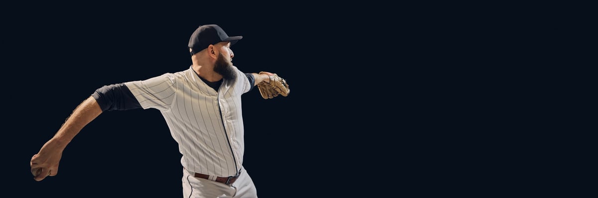 Baseball player rotating shoulders and arm during pitching motion
