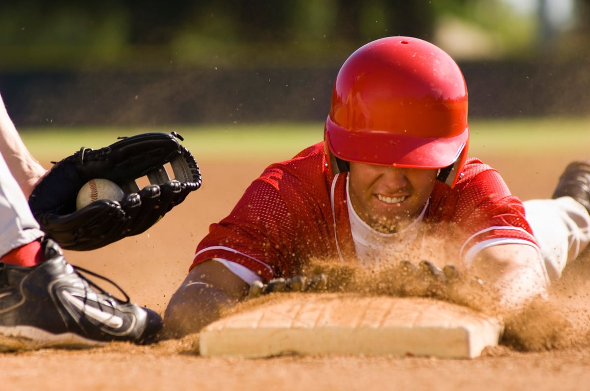 Baseball player sliding into base